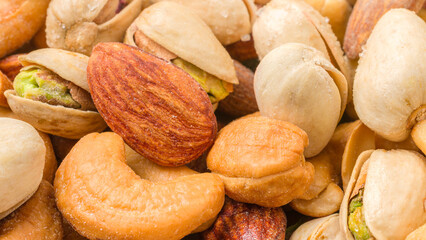 Close-up of roasted nuts, including cashews, almonds, and pistachios.