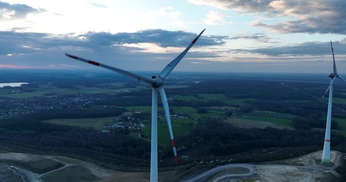 Wind turbine at sunset, dusk, renewable energy. turbing blades, close up, electricty from the wind.