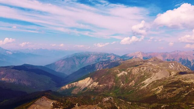 Hyperlapse drone shot tracking behind hikers walking along a mountain trail in the Purcell Mountains, Golden, BC.