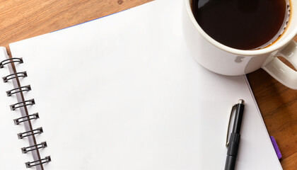 Blank notebook with pen and coffee cup on wooden table  