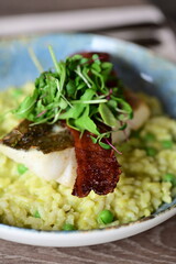 Top View of Pea Risotto with Cod and Crispy Bacon – Spring-Inspired Restaurant Dish