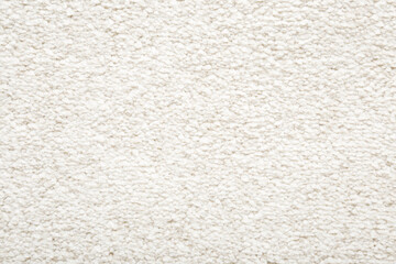 White new fluffy home carpet background. Closeup. Empty place for text. Top down view.