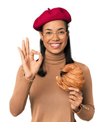 Young Filipina with Parisian look in studio cheerful and confident showing ok gesture.
