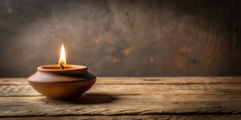 Aromatic clay lamp sits atop a simple wooden table in a serene room