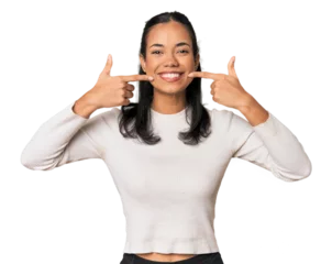 Gordijnen Young Filipina woman smiles, pointing fingers at mouth. © Asier