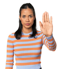 Young Filipina woman standing with outstretched hand showing stop sign, preventing you.