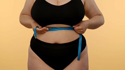 Woman Measuring Waist with Tape for Fitness Progress Tracking