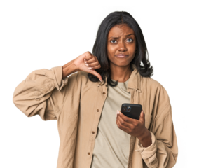 Young Indian woman using a smartphone feels proud and self confident, example to follow.