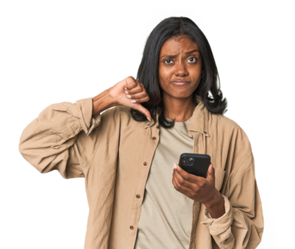 Young Indian woman using a smartphone feels proud and self confident, example to follow.