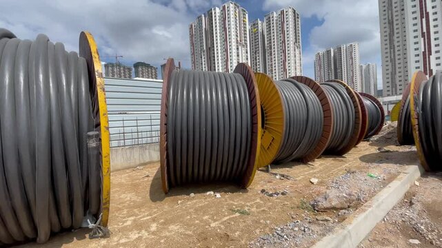 rolls of cable on a construction site background high rise apartments