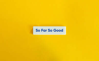 So Far So Good Text on Letter Tile on Yellow Background – Minimalist Progress and Optimism Concept