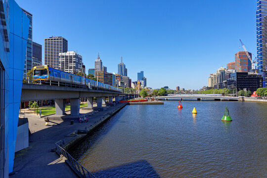 Melbourne Yarra river with oncoming train overlooking city views