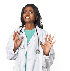 Young Indian doctor with stethoscope rejecting someone showing a gesture of disgust.