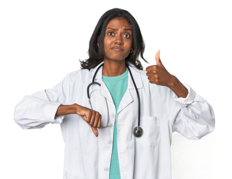 Young Indian doctor with stethoscope showing thumbs up and thumbs down, difficult choose concept