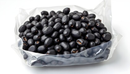 A clear plastic bag filled with small black fruits on a white surface