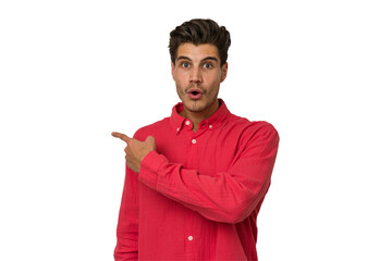 Young handsome caucasian man isolated on white background smiling and pointing aside, showing something at blank space.