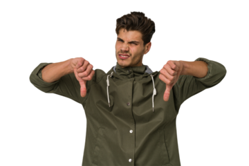 Young handsome caucasian man isolated on white background showing thumb down, disappointment concept.