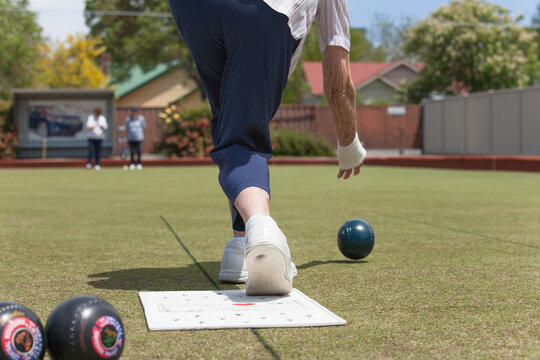 Older woman delivering a lawn bowl