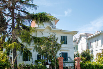 Fototapeta premium white wooden island houses with blue sky in background in istanbul