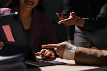 Close up of hand teamwork business group are meeting working overtime and brainstorming about business financial and marketing on paperwork and presentation.