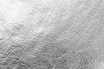 Shiny aluminum foil as background, top view