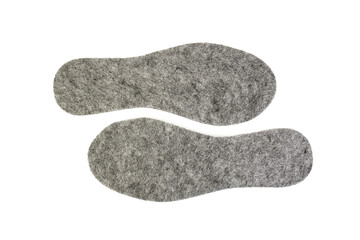 Gray wool felt shoes insoles arranged and isolated on white background, flat lay close up