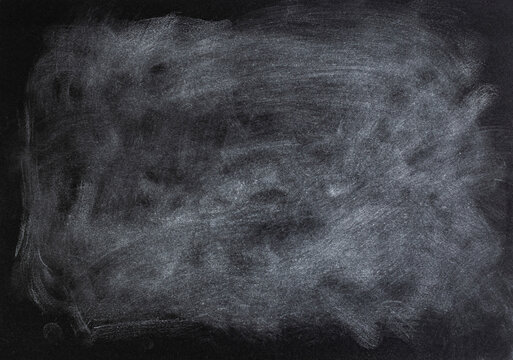 White acrylic pastel smudges on black paper texture, abstract patterned gray backdrop