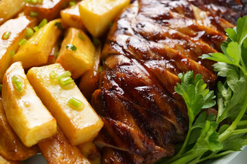 juicy bbq steak with fried potatoes close-up, unhealthy food, tasty food