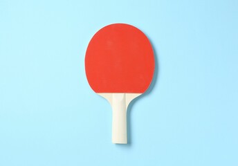 One ping pong racket on light blue background, top view