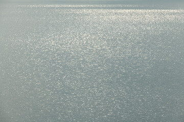 surface of calm lake with reflections in the morning