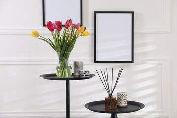 Bouquet of beautiful tulips and decor on tables indoors