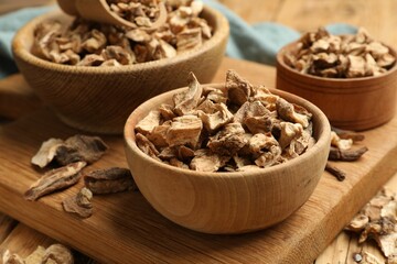 Pieces of dry chicory roots in bowls on table, closeup