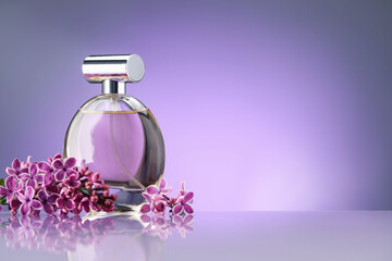 Beautiful lilac flowers and perfume on mirror surface against violet gradient background, space for...