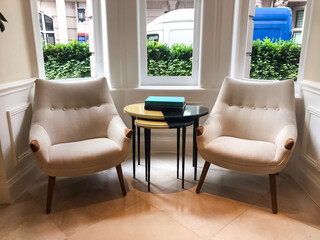 A book placed on a coffee table in the hotel lobby, creating a calm and inviting atmosphere. The soft light and elegant setting emphasize the peaceful and relaxed vibe of the space.