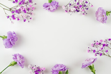 Creative layout of purple flowers composition on white background. Flat lay with copy space.