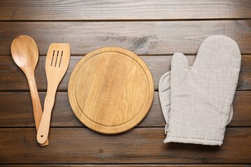 Different kitchen utensils on wooden table, flat lay
