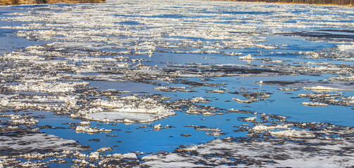 Ice drift on (debacle) the northern river. A rare natural phenomenon after global warming. The ice is melting without movement now