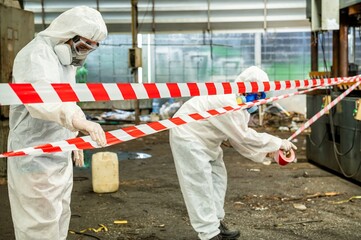 Man inspector scientist investigate chemical gas leak spill with safety face mask PPE suit in area...