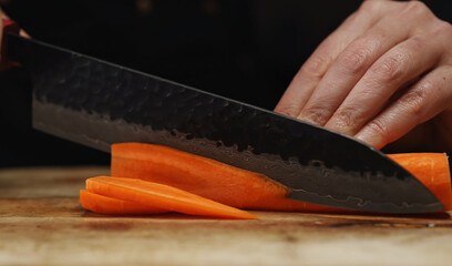Female Chef Slicing Carrots into Julienne Strips.