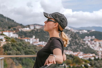Travel,Young female traveler walking alone alongscenic mountain road solo travel, digital nomad...