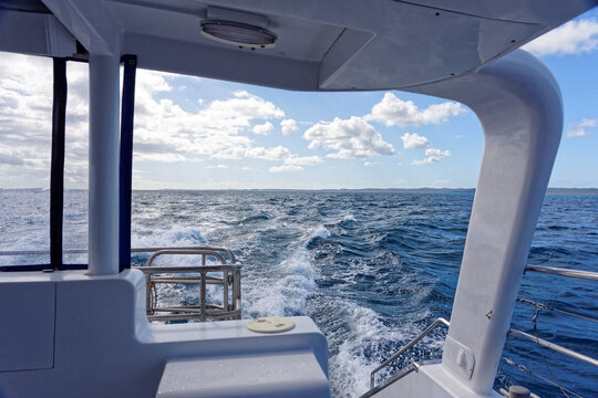 Rear view of waves created by moving boat on the ocean