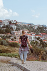 Travel,Young female traveler walking alone alongscenic mountain road solo travel, digital nomad...