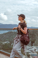Travel,Young female traveler walking alone alongscenic mountain road solo travel, digital nomad...