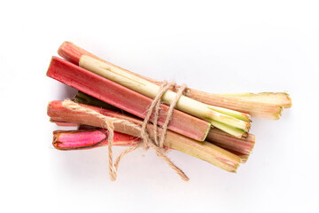 Raw fresh organic rhubarb stems on white background, bunch of homegrown pink and green rhubarb ready for cooking dish, dessert or jam. Summer harvest, cooking ingredient