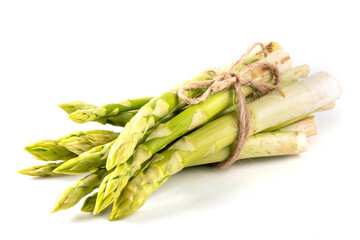 Raw fresh organic asparagus stems on white background, bunch of homegrown green asparagus ready for cooking food. Summer harvest, healthy cooking ingredient