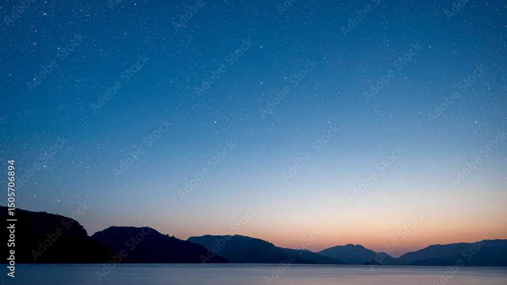 Poster a a movement of stars in the night sky with the view of mountains..