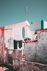 Rustic scene in Aldeia da Mata Pequena with weathered village house walls, satellite dish, and...