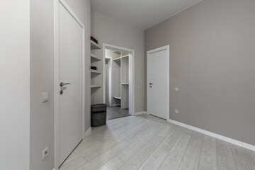 Cozy Modern Hallway with Light Wood Flooring