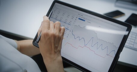 Female Stock Exchange Trader Monitoring and Analyzing Real-Time Stocks, Market Charts in Online...