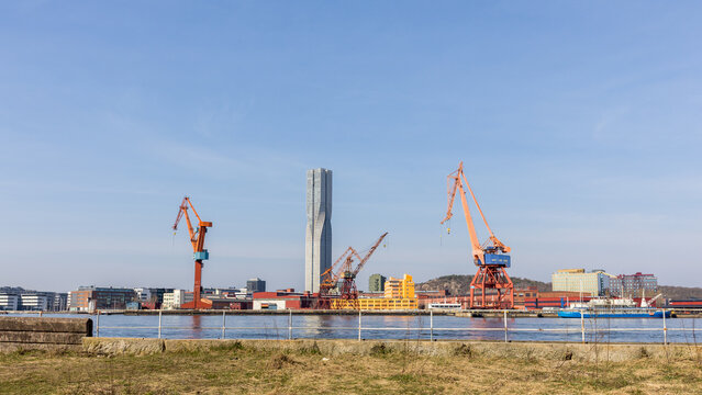 Gothenburg / Sweden, Mar 24, 2025: Karlatornet skyscraper under construction with harbor cranes